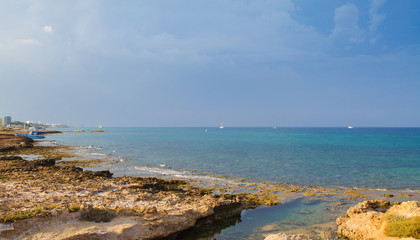 Fototapeta na wymiar Beach and promenade in Protaras, Cyprus, Mediterranean Sea. Sea beach relax, outdoor travel. Copy space background - Image