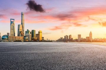 Fototapeta na wymiar Empty asphalt road through Shanghai business district at sunset