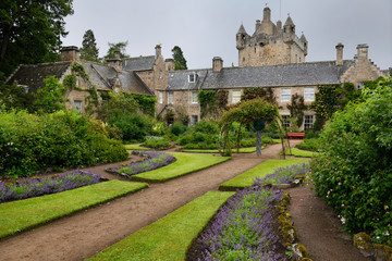 Fototapeta na wymiar Wet Flower Garden with purple perennial flowers south of Cawdor Castle after rainfall in Cawdor Nairn Scotland UK