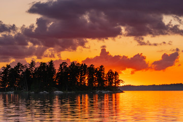 Fototapeta na wymiar Orange Flow from Sunset Over Lake