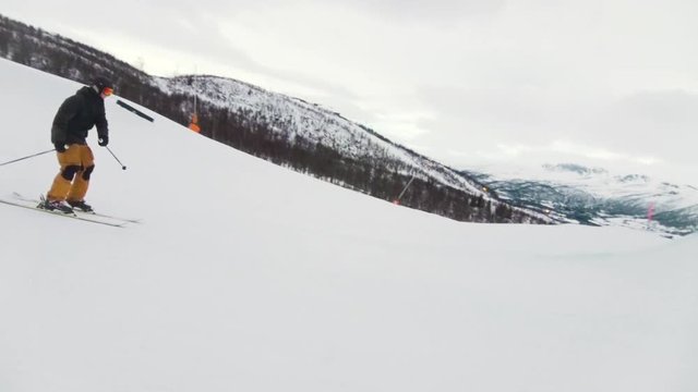 skier doing a full rotation 360 on a jump, follow cam in slow motion