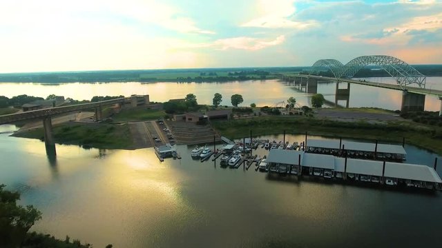 Aerial view of Marina on the Mississippi river with the Hernando de Soto Bridge to the side, during sunset.