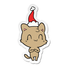 sticker cartoon of a happy cat wearing santa hat
