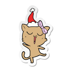 sticker cartoon of a cat wearing santa hat