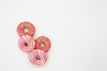 Picture of donuts  frosted, pink glazed and sprinkles donuts isolated on white background