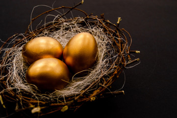 Easter golden decorated eggs on dark background. Minimal easter concept. Happy Easter card with copy space for text. Top view, flatlay.