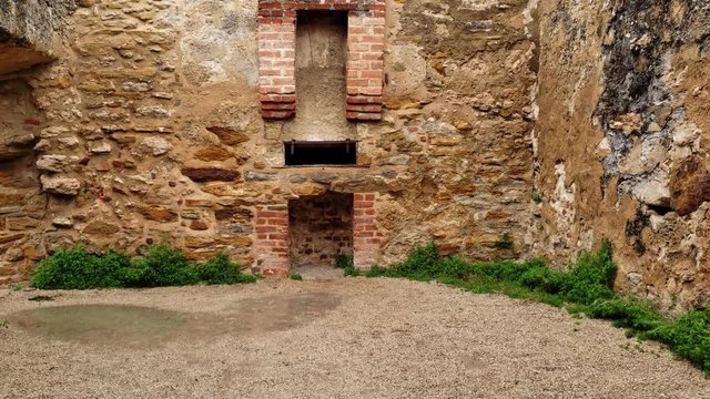 first person view walking through a old castle doorway into the ruins and fireplace of old room
