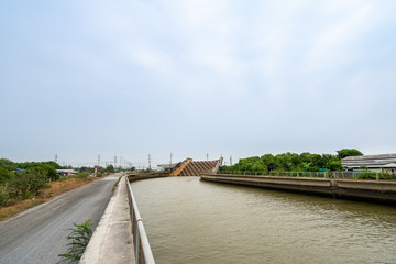 Fototapeta na wymiar aqueduct water bridge across road for drainage water to sea at Suvarnabhumi thailand (building for prevent flood airport) with blue sky