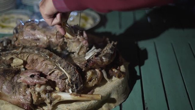 Man carving grilled meat