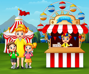 Obraz na płótnie Canvas Happy kids and their parent having fun in an amusement park