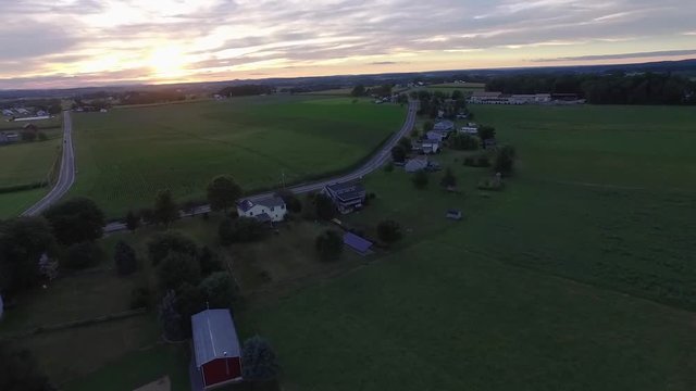 Aerial view of a farmland with a road and a group of houses in Lancaster county Pennsylvania.