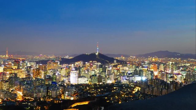 Night time lapse of the illuminated city of Seoul with the Seoul Tower in the background.