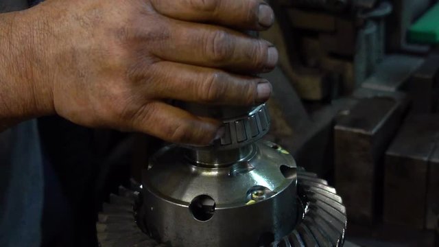 Mechanic pressing bearings onto differential