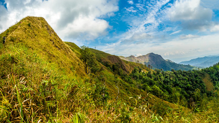 Mountain peak range landscape.  Green mountain range view. Mountain peak blue sky white clouds panorama