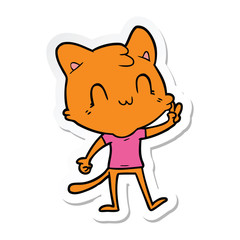 Obraz na płótnie Canvas sticker of a cartoon happy cat giving peace sign