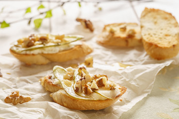 Bruschetta or crostini with ricotta, pear, walnuts and honey.