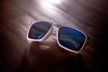 white sunglasses on wooden background