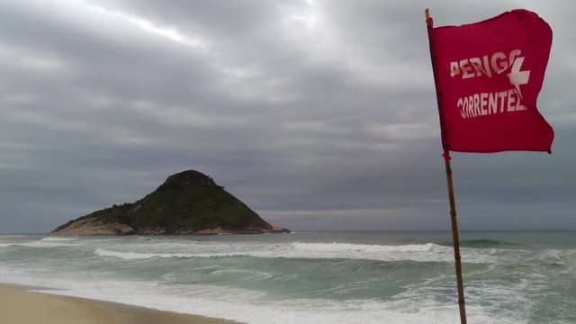 Braziliam sigh of dangerous current on the sea in Brazil, rio de Janeiro, Macumba beach in a cloudy day