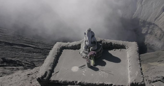 Ganesha Hindu god statue on the edge of Bromo crater Lord of Success on Crater mouth of Bromo Mountain active volcano, Indonesia