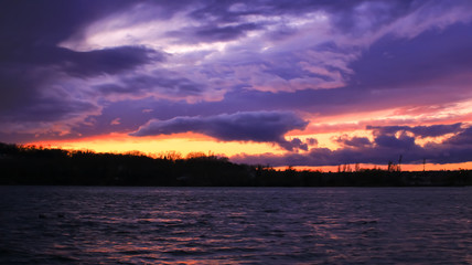 Obraz premium Dark sky above the water had gray and colorful clouds. Sunset at the approach of a rainstorm over island