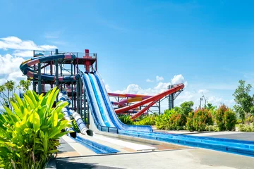 Fotobehang colorful large slider at amusement water park or aquapark in beautiful cloudy and blue sky day © Surasak
