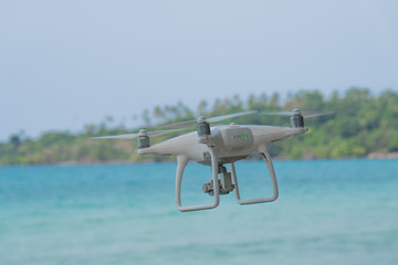 flying drone with blue sky ocean island background
