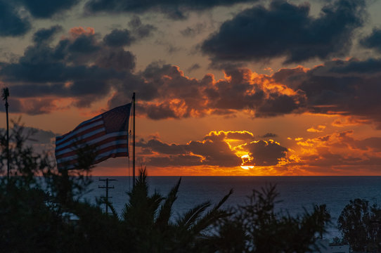 Dramatic Cloudy Sunset with Flag