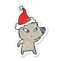 cute distressed sticker cartoon of a bear wearing santa hat