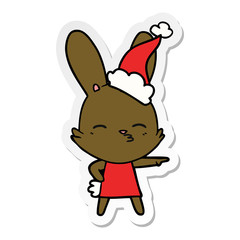 curious bunny sticker cartoon of a wearing santa hat