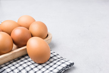 Fresh Eggs (chicken) Close-up with stone white background.