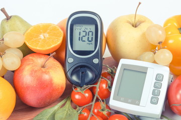 Glucometer with sugar level, blood pressure monitor and fruits with vegetables, healthy lifestyle