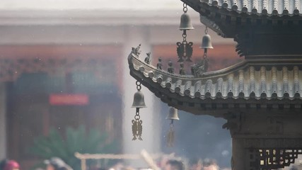 Immortal and beasts on the eaves of the building in Shanghai Jingan temple, Imperial yellow roof decorations, Wind bells under eaves sway with the wind, 4K video, slow motion. 