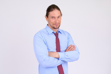 Portrait of happy businessman smiling with arms crossed