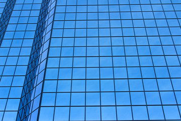 Blue windows reflection on a tall building
