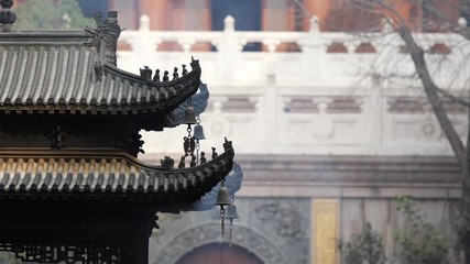 Immortal and beasts on the eaves of the building in Shanghai Jingan temple, Imperial yellow roof decorations, Wind bells under eaves sway with the wind, 4K video, slow motion. 