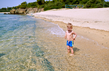Toddler boy on beach