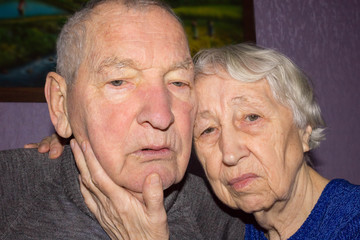 Portrait of a sad elder couple at home