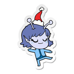 smiling alien girl sticker cartoon of a wearing santa hat