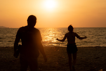 father and  Daughter on the beach at sunset