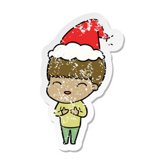 happy distressed sticker cartoon of a boy wearing santa hat