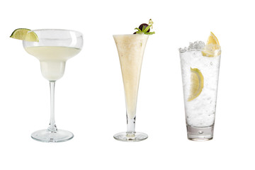 A variety of alcoholic drinks, beverages and cocktails on a white background. Three drinks in different glass goblets.