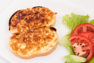 Grilled sandwiches with egg and cheese for breakfast. Decorated with vegetables in white plate