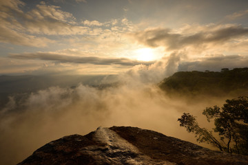 Fog is forming over a cliff in twilight time