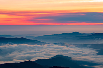 Mountain landscape with winter fog at sunse of Ceahlau, Romaniat