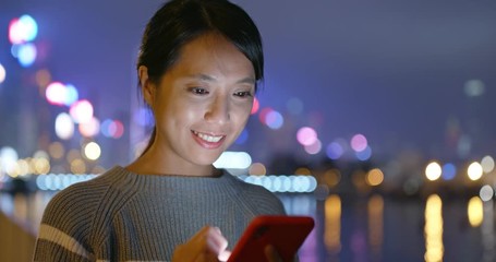 Asian Woman use of mobile phone at night