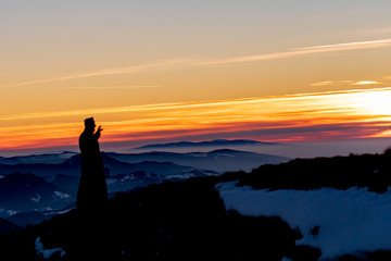 Priest silhoute reading in the sunset light, Romania