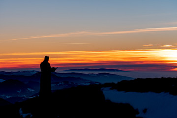 Priest silhoute reading in the sunset light, Romania