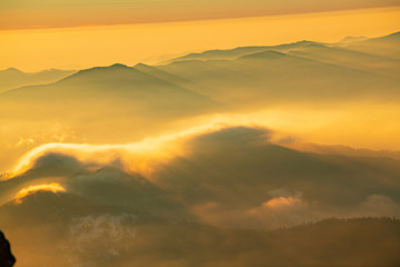 Mountain landscape with winter fog at sunse of Ceahlau, Romaniat