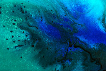 Abstract painting drawn by fluid acrylic technique. Creative design wallpaper for desktop. Picture with blue, green water stains, gradients, black spots on dark background. Modern art concept.
