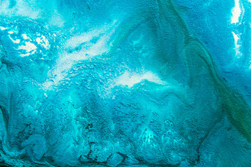Fototapeta premium Abstract painting drawn by fluid acrylic technique. Picture with emerald, green, mint colorful water stains, gradients on blue background. Imitation of sea ocean waves on canvas. Modern art concept.